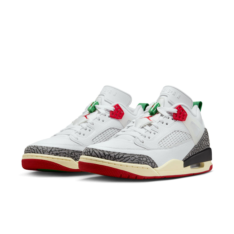 Men’s low-top sneakers pair, white uppers with black speckled side, red sole edge