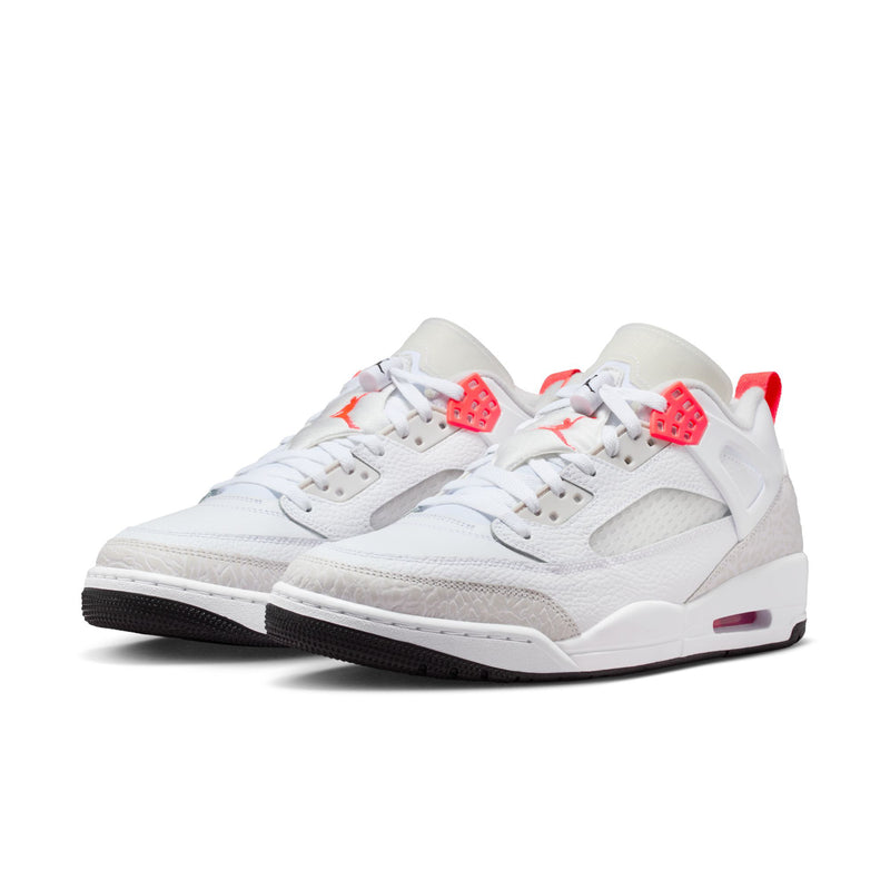 White low-top sneakers with red-orange heel tab and side panel, lace-up design
