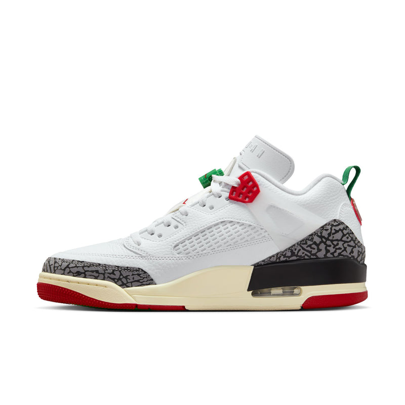 Men’s low-top sneakers side view, white leather with black speckled trim, red sole
