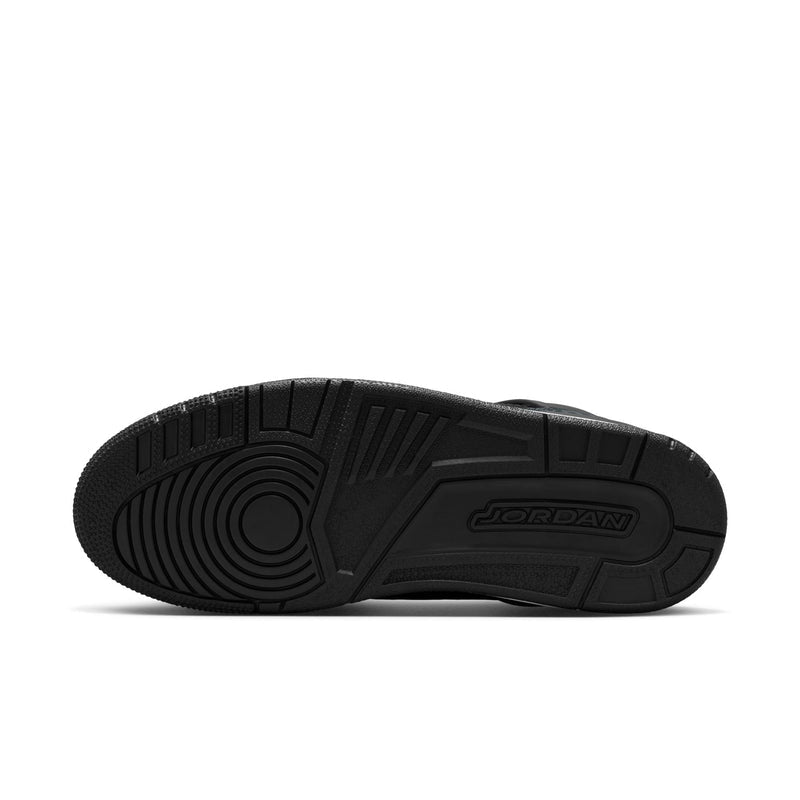 Men's black low-top sneakers, underside view with textured outsole tread.