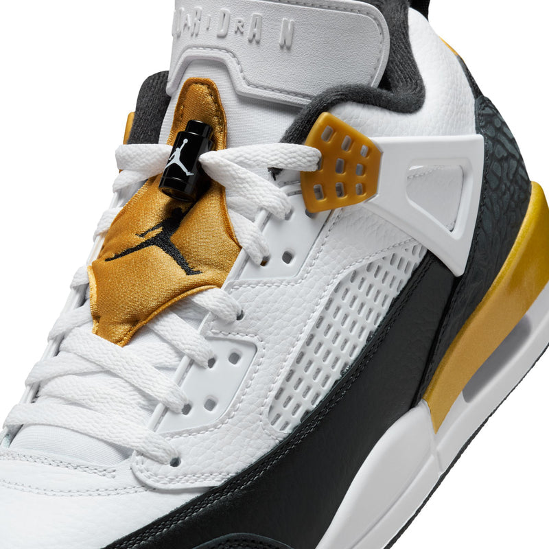 Close-up of men's low-top sneakers: white laces, gold tongue tag, and black Jumpman logo.