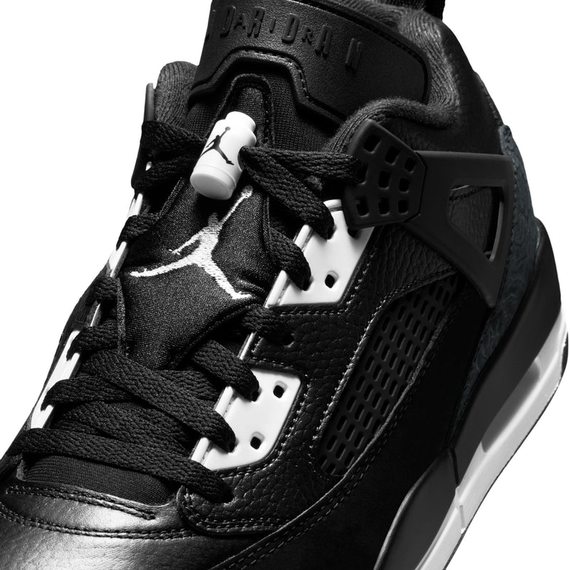 Men's black low-top sneakers close-up of lace area with white eyelets and panels.