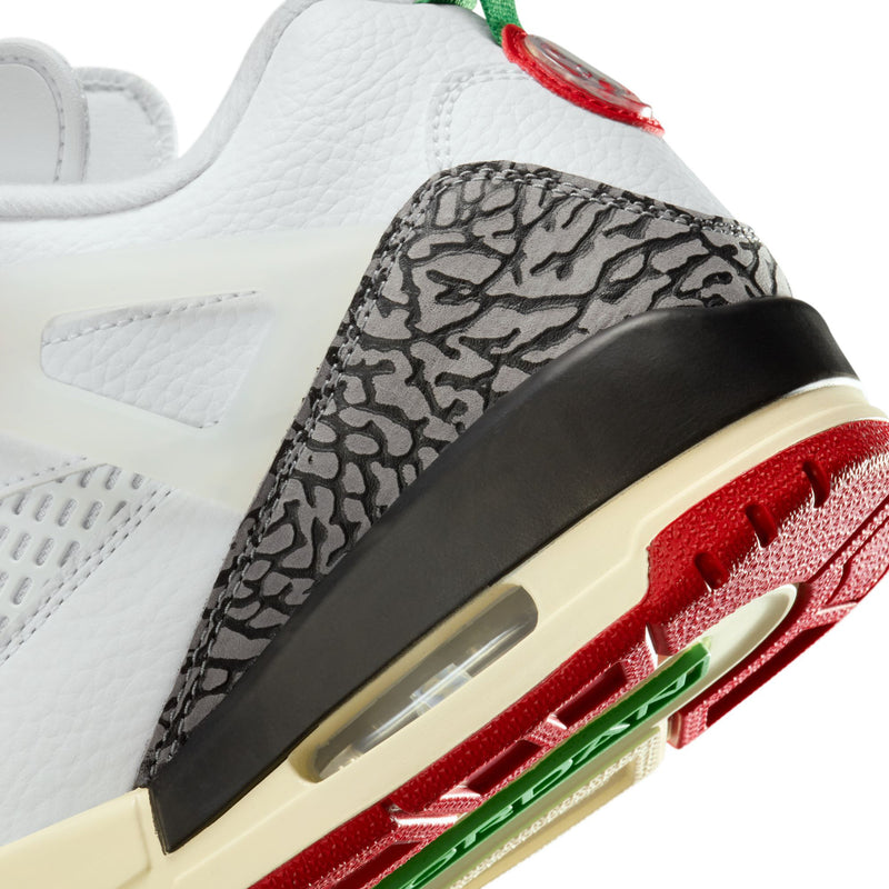 Men’s sneaker side detail, black panel with air window, red traction and green accents