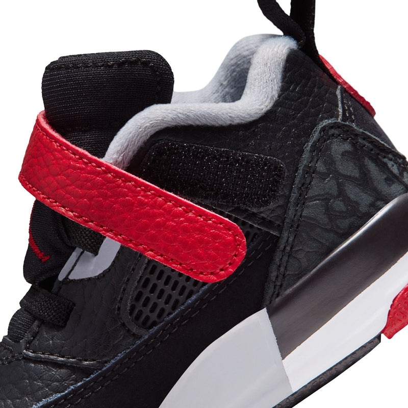 Toddler sneaker close-up with red strap, black leather, gray lace panel, white midsole