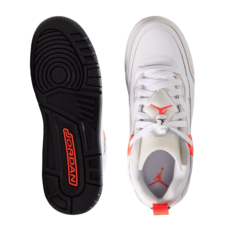White youth sneakers shown with black outsole and red Jumpman branding on toe