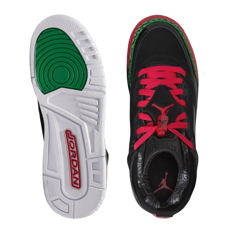 Shoe outsoles with green tread insert and red branding on black shoe
