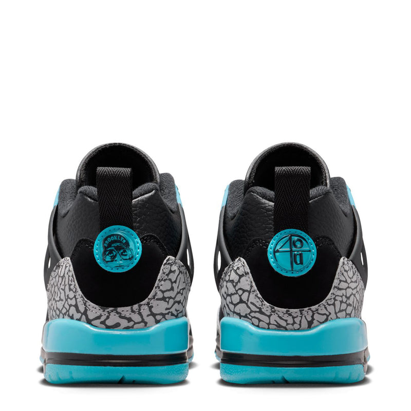 Youth low-top sneakers back view, black heel with turquoise tabs and speckled midsole