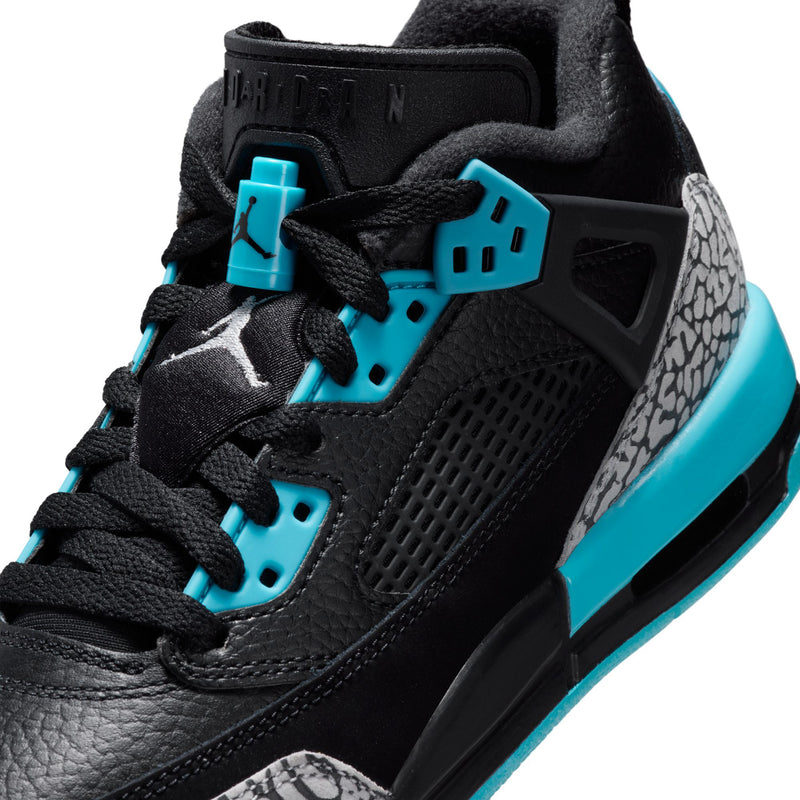 Youth low-top sneaker close-up, black leather upper with turquoise laces and Jumpman detail