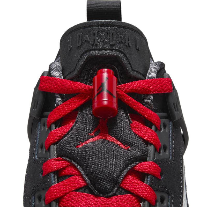 Youth sneaker tongue and lace area in black with red lace loops and molded logo
