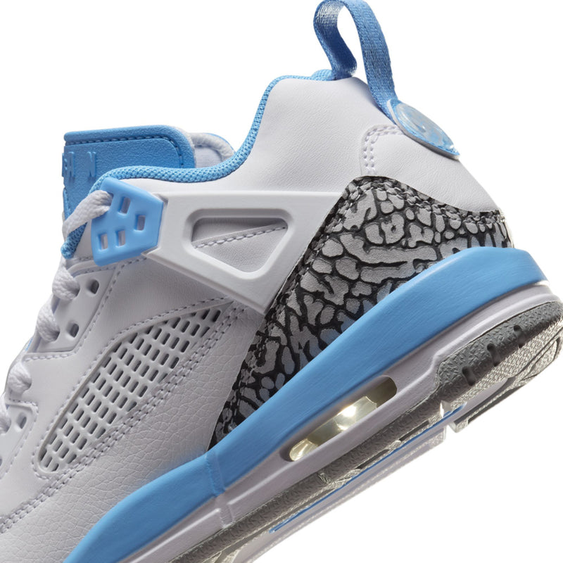 Close-up youth low-top sneakers: blue cage detail, speckled side panel, visible air window