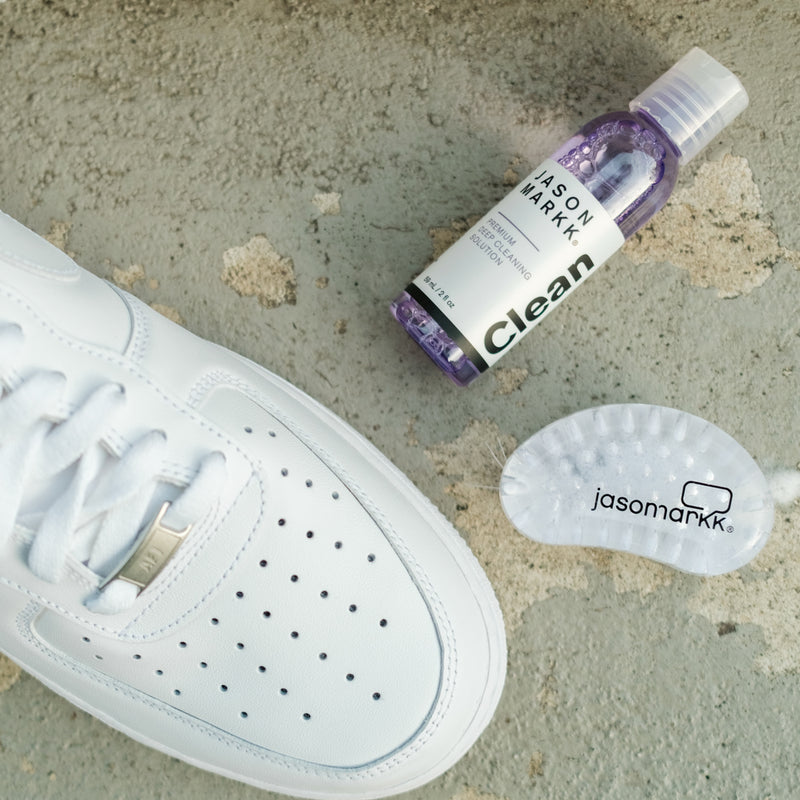 White sneaker with premium cleaning bottle and oval brush for shoe soles