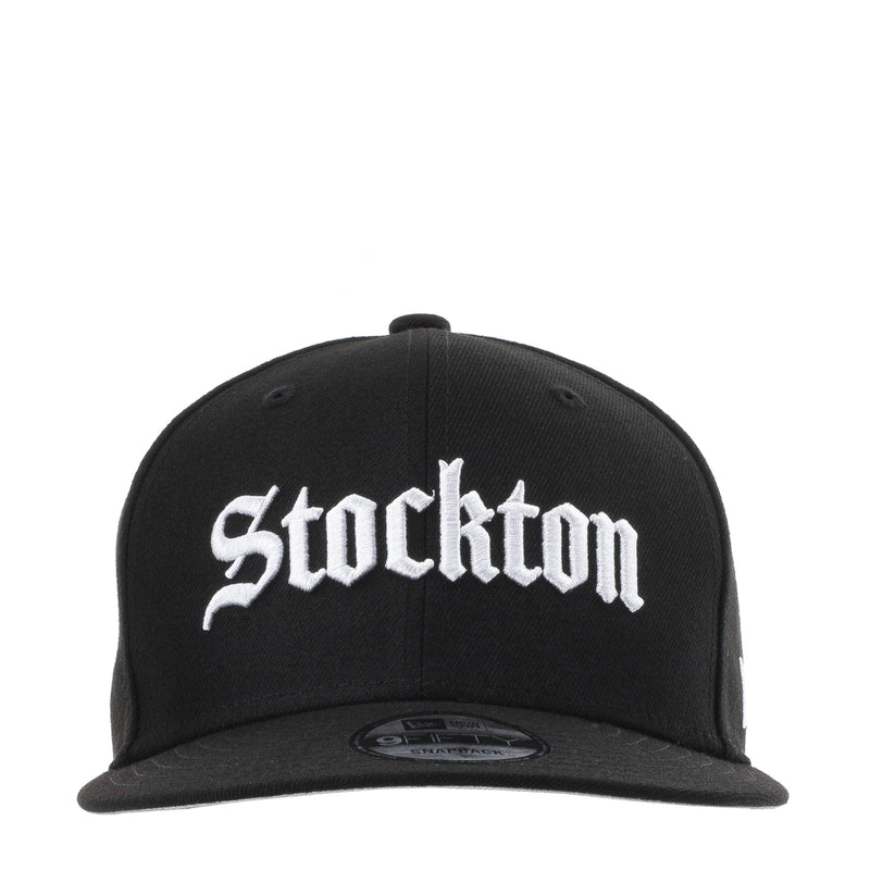 Black baseball cap with white Stockton logo, flat brim and adjustable strap
