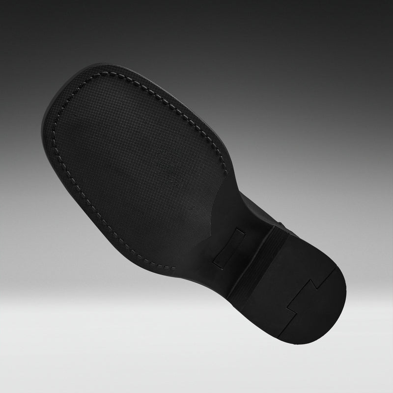 A close-up of a black shoe sole, showing the textured tread and stitched edge, set against a dark gray gradient background.