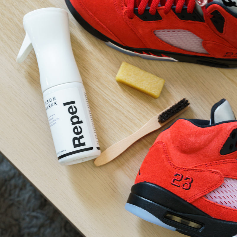 Suede cleaning tools: Repele spray canister, brush, and yellow eraser block