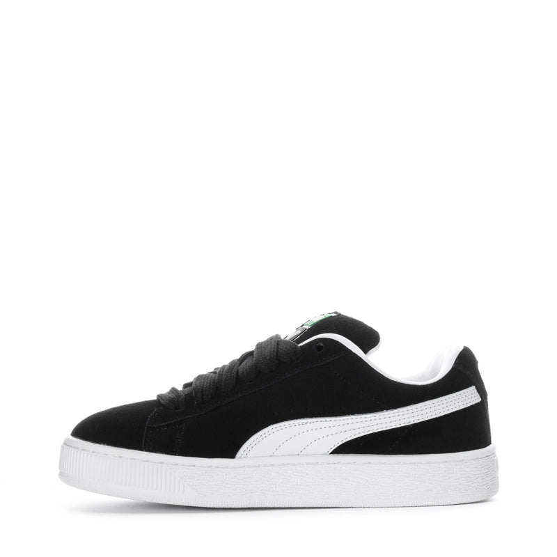 Black suede youth sneakers side view with white stripe and chunky white midsole