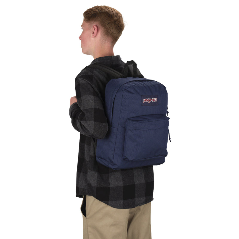 Person wearing navy Jansport backpack from the side