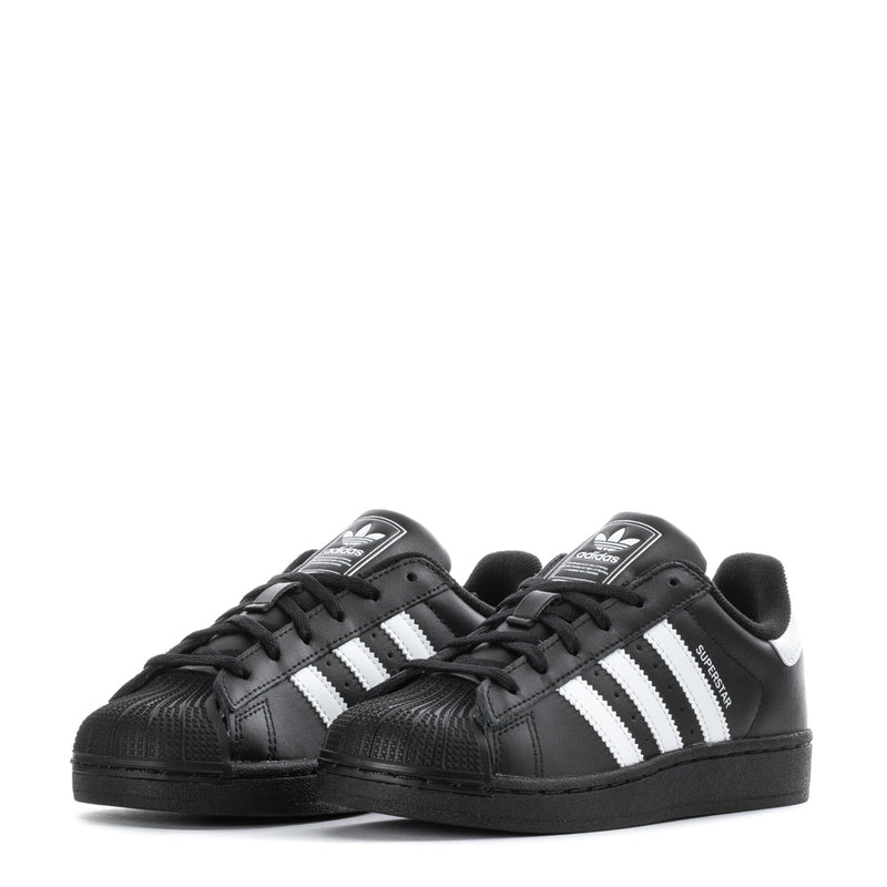 Pair of kids black Adidas Superstar II sneakers, angled front view with white stripes