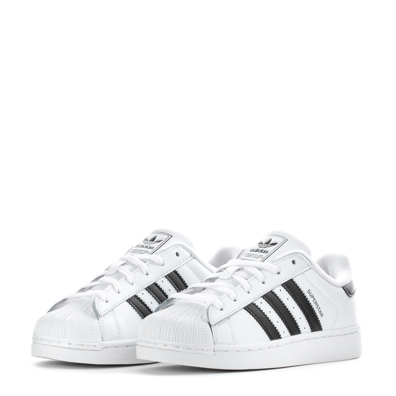 Kids' adidas low-top sneakers, front pair view in white with black three-stripe details