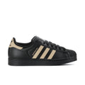 Black leather low-top sneakers with beige three-stripe design and black lace-up.