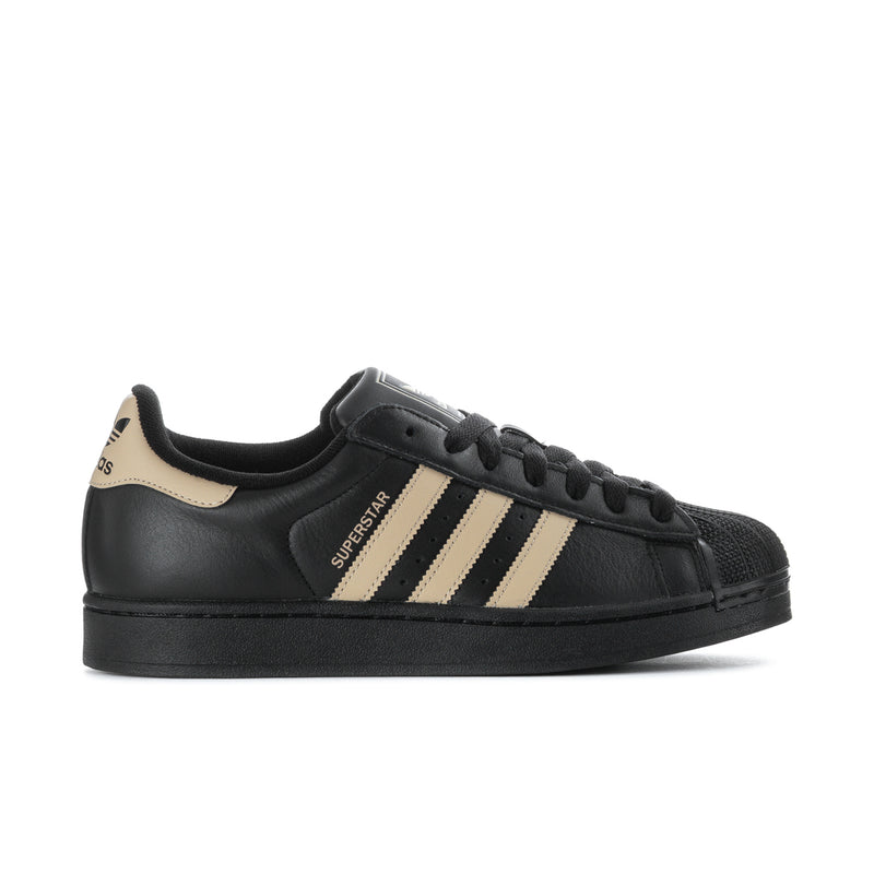 Black leather low-top sneakers with beige three-stripe design and black lace-up.