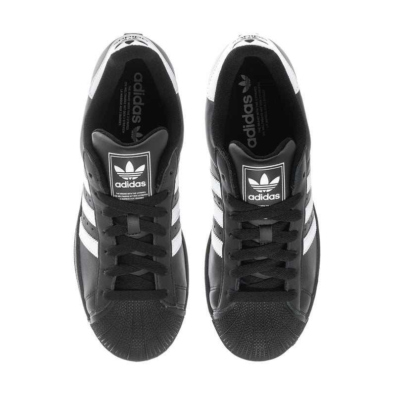 Black leather sneakers with white striped panels and lace-up front