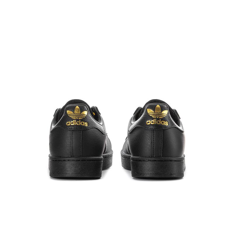 Men's black Adidas sneakers, back view with gold trefoil logo on heel.