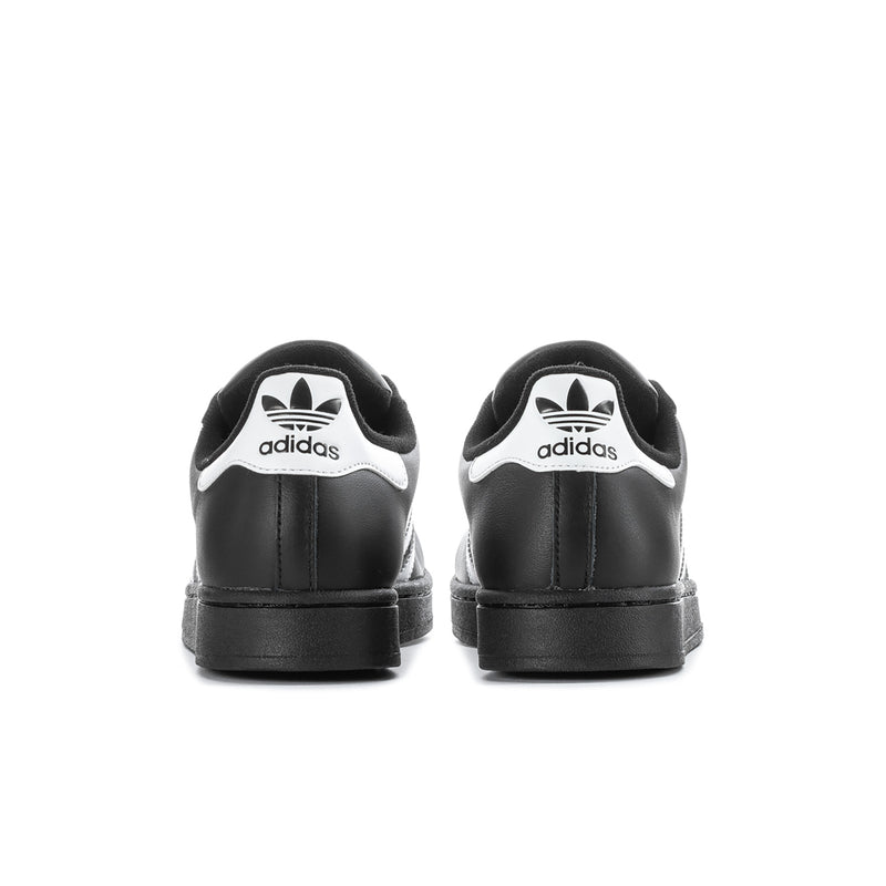 Black leather sneakers with white adidas heel logo, back view