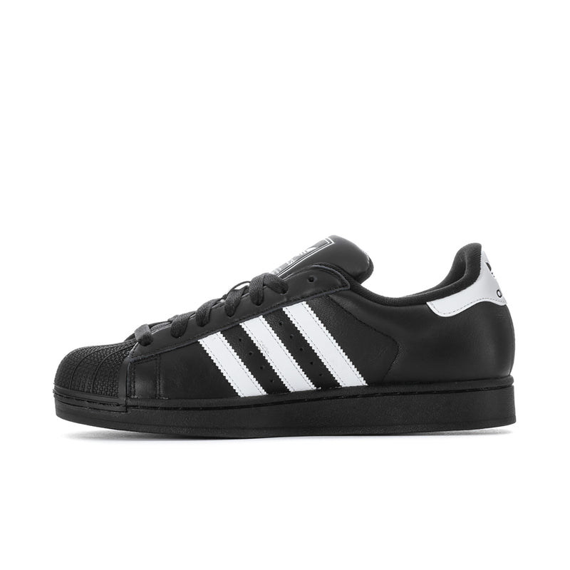 Black leather lace-up sneakers with white center stripes and cupsole