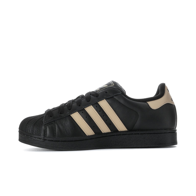 Black leather adidas sneakers with beige triple stripes and black lace-up.