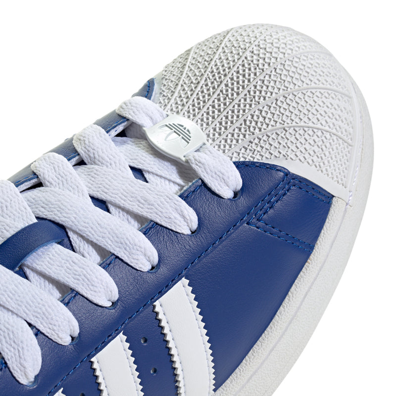 Men's Superstar II sneakers close-up, white laces and three blue panels with stitching