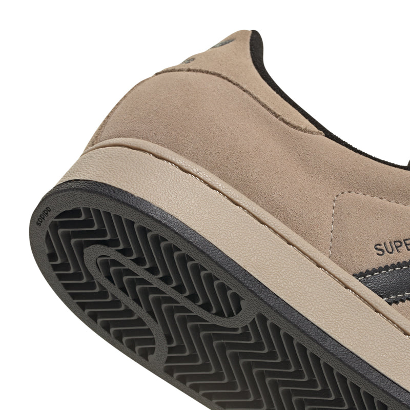 Tan suede heel with black cupsole edge and textured rubber tread