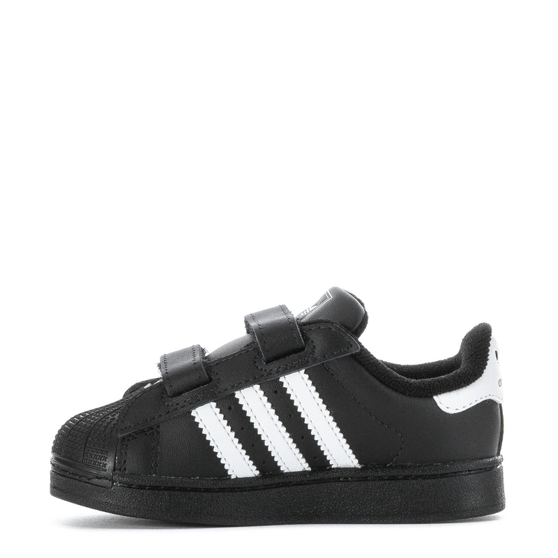 Toddler black sneakers with three white stripes and dual Velcro closures