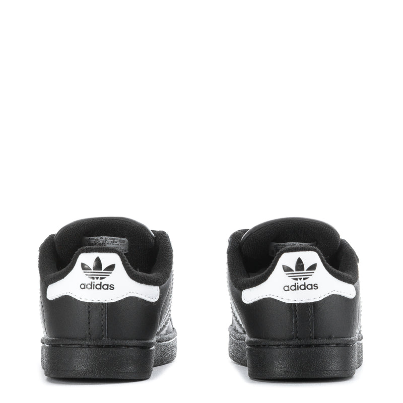 Toddler black sneakers with white adidas logo on heel and Velcro closure