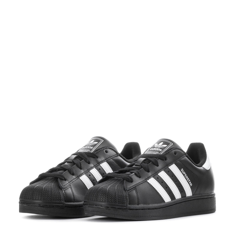 Pair of black low-top lace-up sneakers with white three-stripe side and dark rubber sole.