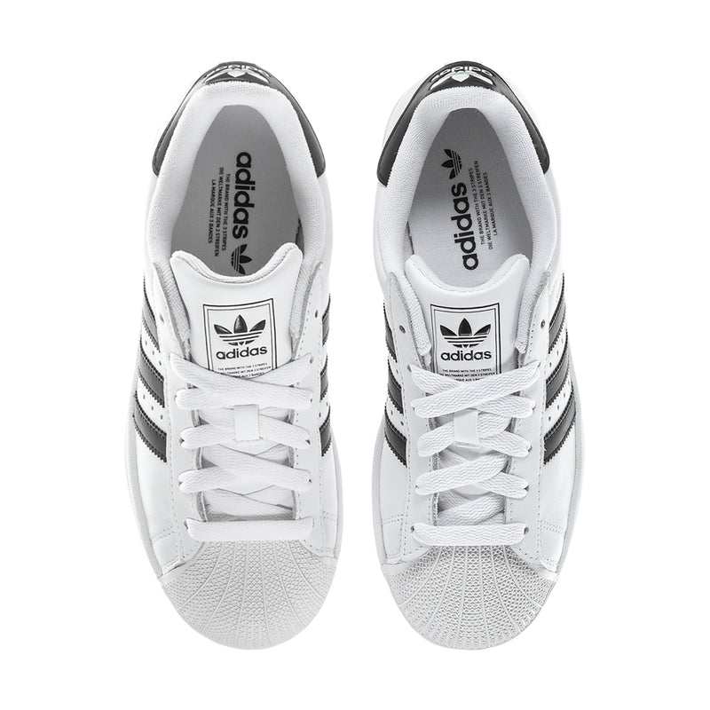 Women's white sneakers with black accents, lace-up front and adidas logo on tongue