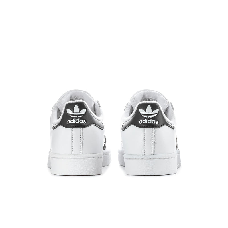 Women's white low-top sneakers, rear view with adidas trefoil on heel tab