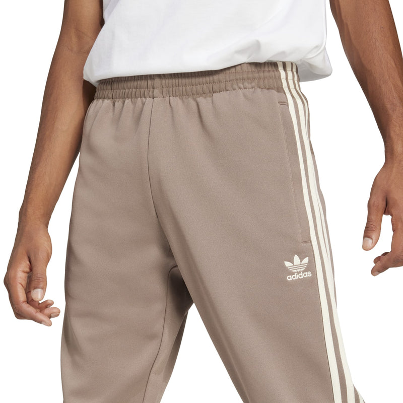Men's taupe track pants with elastic waistband, white side stripe, adidas logo