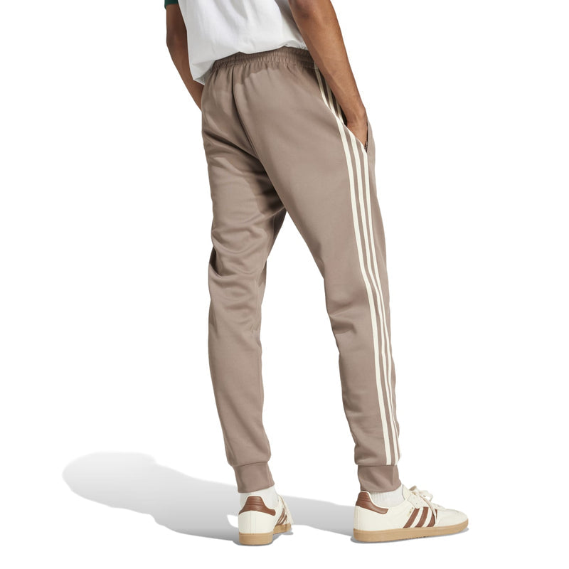 Men's taupe track pants with white side stripes and tapered fit