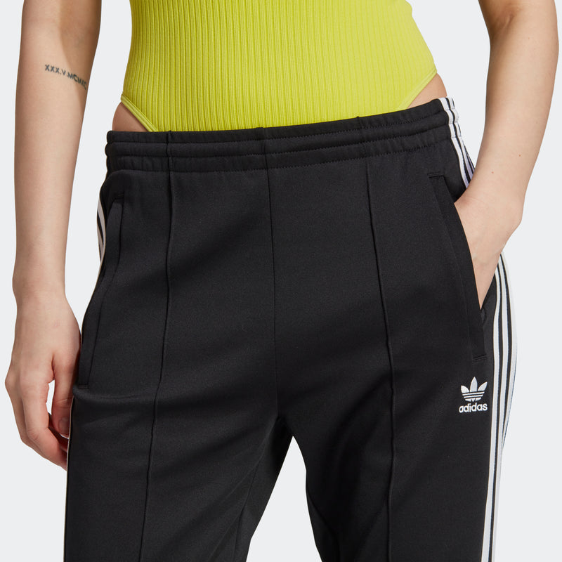 Women's black track pants with elastic waistband and adidas logo on thigh