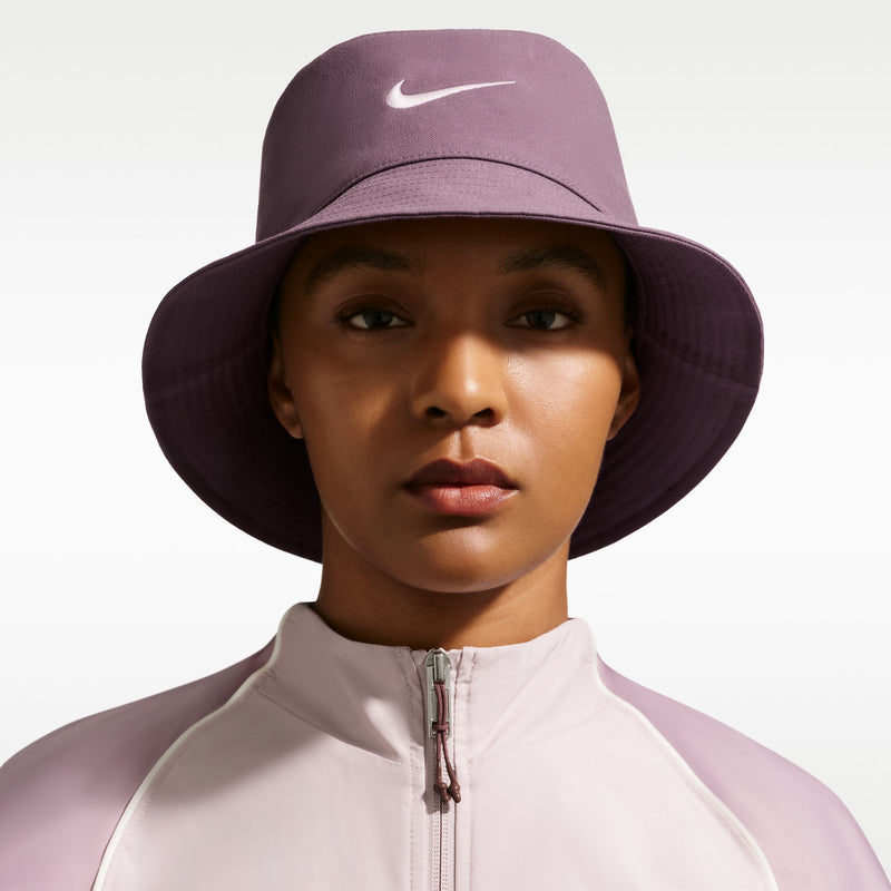 Mauve Nike bucket hat with white Swoosh logo on crown