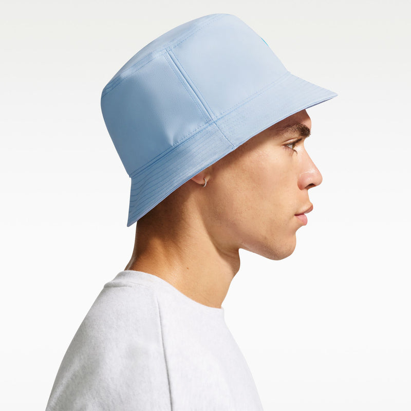 Light blue Nike bucket hat angled side view with wide brim