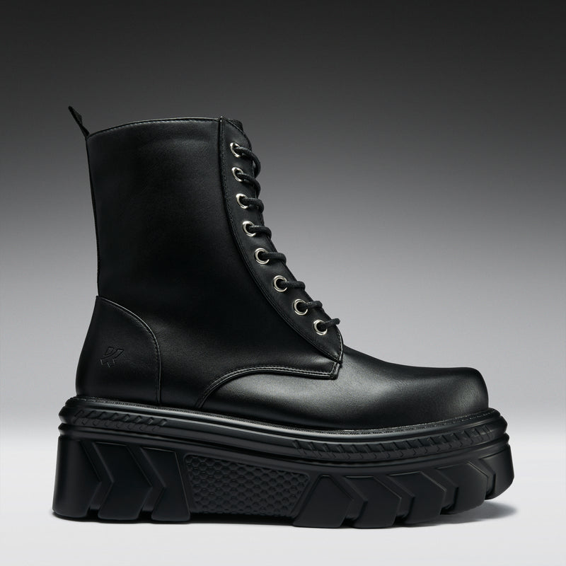 Black leather boot with thick sole on a gradient background