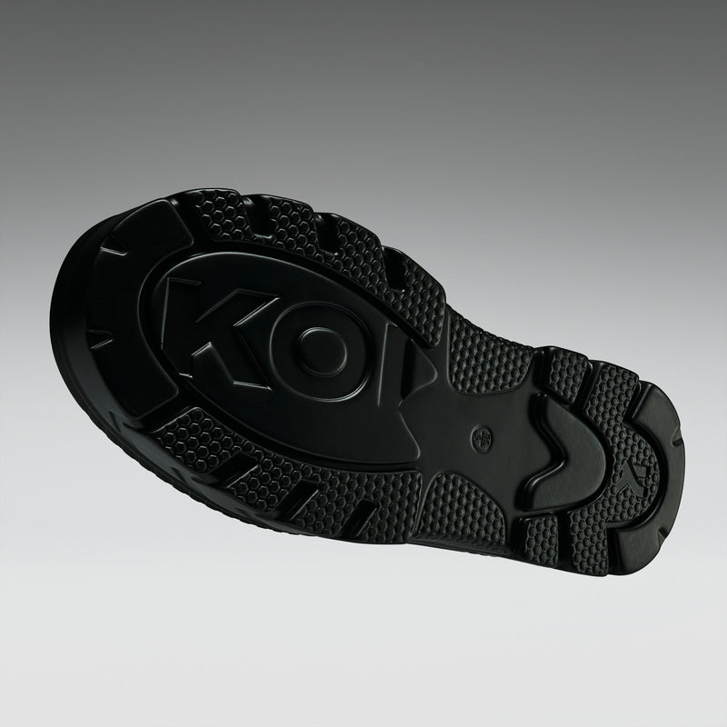 Black sole of a shoe with a brand logo on a gray background
