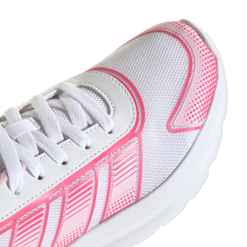 Close-up of youth running shoe, white laces and pink-striped side with mesh texture