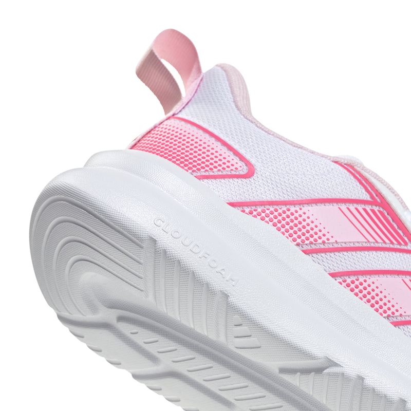 Close-up of youth running shoe outsole with tread, pink and white upper