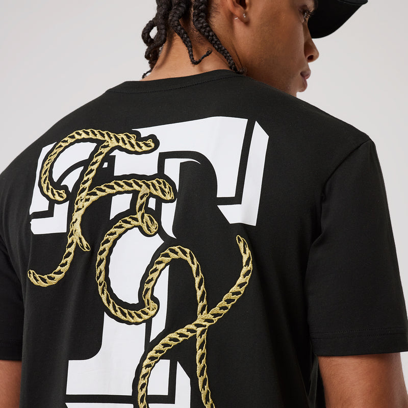 Men's black tee back graphic with large white letter 'R' and gold rope trim