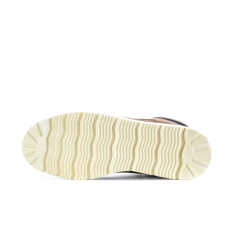 Boot outsole with cream tread pattern; brown upper edge visible
