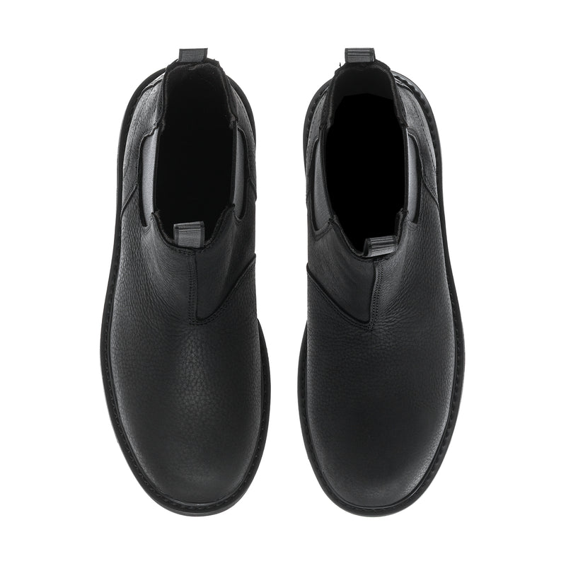 Black men’s Chelsea boots showing rounded toe and side elastic panel.