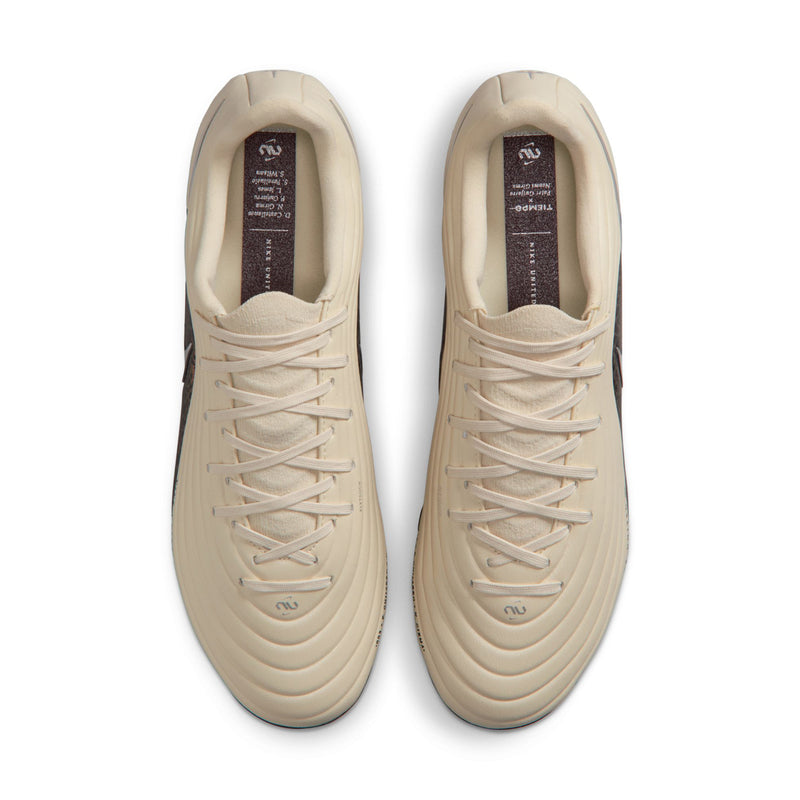 Pair of men's soccer cleats, cream uppers with laced front and padded tongue