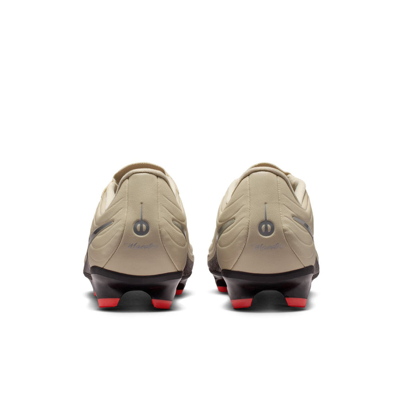 Rear view of men's soccer cleats, cream uppers with red-studded sole